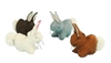 Quatre petits lapins en feutre de laine, tous quatre avec une queue blanche, un blanc, un gris, un bruin clair et un brun foncé.