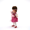 Erna Meyer Lisa dollhouse doll with pink dress holding a doll in her arms, side view.